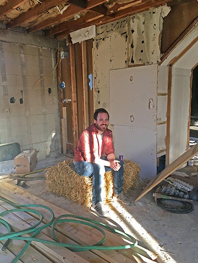 Drew sits amid rubble in the “before” stage of his current project in Knoxville, Tennessee