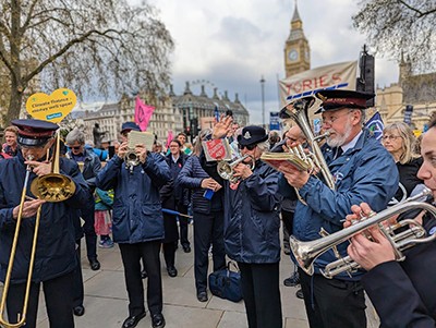A Salvation Army band leads the No Faith in Fossil Fuels march